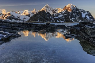 Sunrise, morning light, steep mountains by the sea, winter, Flakstadoya, Lofoten, Norway, Europe