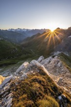 Mountain landscape at sunrise with sun star, view of mountain peaks of the Venediger group and into