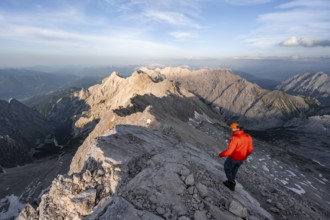 Mountaineers on a steep rocky ridge, impressive mountain landscape, view of the Höllental and the