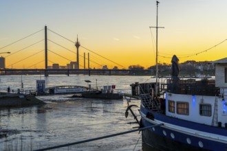 Sunset on the Rhine near Düsseldorf, skyline of the city centre with Rhine Tower, Rheinkniebrücke,