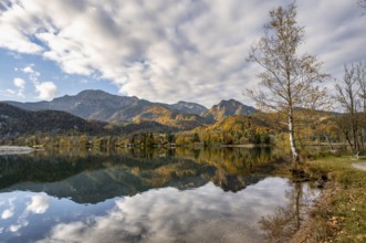 On the shore of Lake Lake Kochel with reflection, autumn landscape with mountain peaks Herzogstand