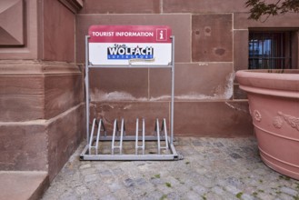 Bicycle stand with advertising City of Wolfach, tourist information centre, flower bucket, main