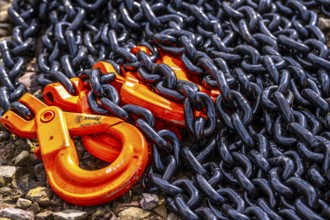 Heavy, thick chains made of steel, black chain links, orange painted hooks, Germany, Europe