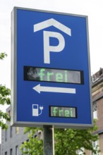 Information board in a multi-storey car park, also indicating availability for charging stations