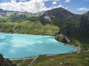 Dam of the Moiry lake, Lac de Moiry, turquoise glacial water, parking lot and restaurant at the