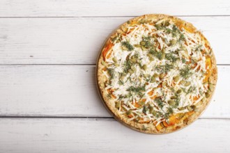 Sweet pumpkin pie with cheese and dill on white wooden background. top view. copy space