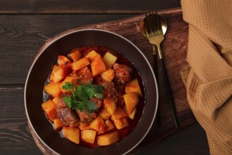 Potatoes stewed with meat, in tomato sauce, with spices and herbs, no people