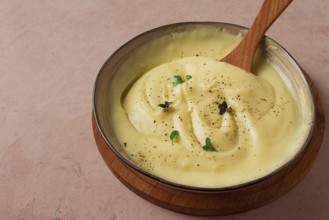 Mashed potatoes, with micro greenery and spices, homemade, on a beige table, no people, top view