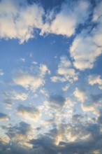 Fleecy clouds adorn the blue evening sky