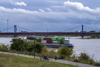 Cargo ship, loaded with containers, on the Rhine near Duisburg, the wheelhouse is raised to ensure