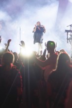 At night at an open-air concert, singer on stage, large crowd, Klostersommer, Calw Hirsau, Black