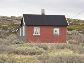 Holiday home on the shore of the Arctic Ocean, beside the town of Nesseby, May, Varangerfjord,