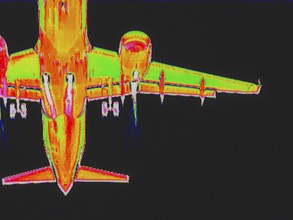 Aircraft on approach, bottom view. Thermal image or thermography, symbol photo, interpolated.