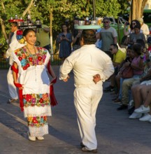 Folk dancers with drink trays balanced on their heads, Francisco Cantón Rosado Park, Valladolid,