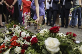 People lay flowers during a commemoration event on the anniversary of the German invasion of Poland