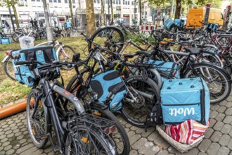 Wolt delivery service, parked bikes of bicycle couriers with thermal backpack, in front of the main