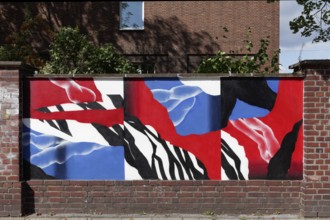 Abstract painting in blue and red colour on an old brick wall, decorative street art commissioned