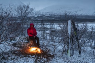 Man at the campfire, Stora Sjöfallet National Park, World Heritage Laponia, Norrbotten, Lapland,