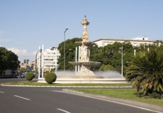 Fountain and sculpture in a road roundabout, Plaza de Don Juan de Austria, Seville, Spain, Europe