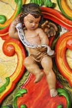 Wooden figure, colourfully painted, cherub at a carousel organ, fairground organ, historic