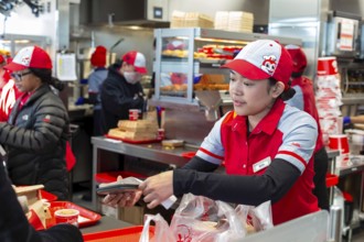 Sterling Heights, Michigan, Workers serve up Chickenjoy fried chicken at Jollibee, a Filipino fast