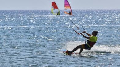 Kitesurfer rides over the sea in sunny weather, surfer's paradise, kitesurfer, windsurfer,