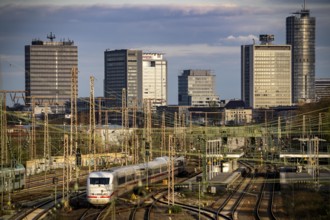 Train on the tracks west of Essen central station, skyline of the city centre, ICE train, North