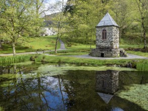 Springtime at the park of baroniet Rosendal, pond with tower, old castle, Rogaland, Norway, Europe