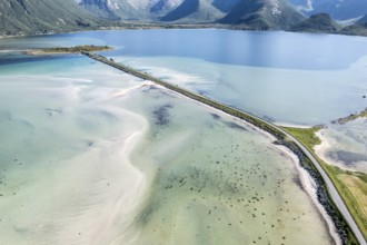 Aerial view of a bridge over turquoise sea at a sandy beach, fjord Grunnforfjorden, Lofoten