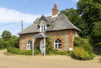 Flint and thatched historic country cottage former estate worker's home, Sutton, Suffolk, England,