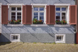 Windows with shutters and flower boxes on a house in Gengenbach, Black Forest, Ortenaukreis,