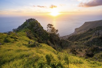 Evening mood, green coastal landscape on a steep cliff at sunset, sea and coast, viewpoint