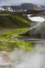 Colourful volcanic landscape with hills and snow, volcanic steaming hot springs, Laugavegur