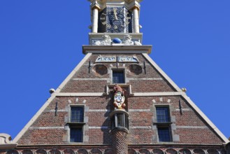 City coat of arms with unicorn and post horn on the historic Hoofdtoren defence defence tower in