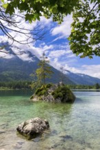 Hintersee near Ramsau with clear green water, surrounded by forests and mountains under a cloudy