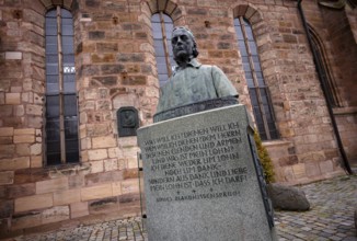 Wilhelm Löhe monument, bronze bust on a high granite stone plinth with three bronze reliefs, by