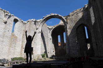 Silhouette of a girl with outstretched arms, church ruins, Hanseatic city of Visby, UNESCO World