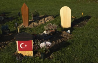 Muslim graves strictly orientated towards Mecca, national flag of Turkey on gravestone, main