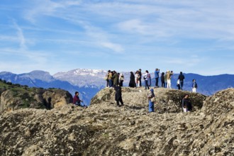 Group of tourists on rocks, enjoying the view, Meteora, blue sky, Thessaly, Greece, Europe