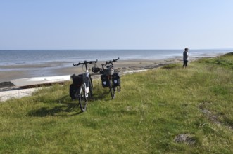 Woman, senior citizen cycling through Jutland in Denmark