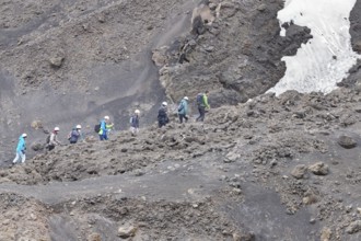 Group of hikers walking up to Mount Etna summit, Etna, Sicily, Italy, Europe