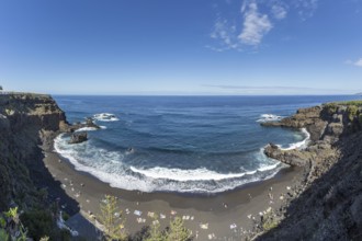 The lava beach lined with bathers, Playa del Bollulo, near Puerto de la Cruz, Tenerife, Canary