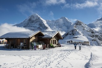 Wooden chalet and ski slope, with views of the Eiger, Mönch and Tschuggen, Grindelwald, Bernese