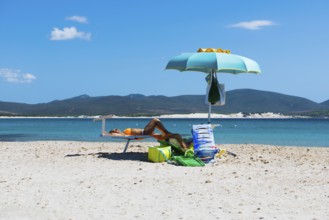 Woman in a deckchair on the beach, Porto Pino, Sardinia, south coast, Italy, Europe