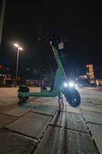 E-scooter at night on an illuminated street in the city, Stuttgart, Germany, Europe