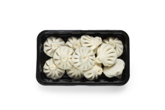 Freshly frozen, raw khinkali, in a black plastic container, top view, no people, Georgian cuisine