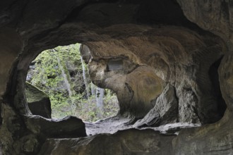 The Hohllay cave showing grooves and circles in the sandstone rock from carving millstones,