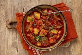 Potatoes with meat, stewed in tomato sauce, with spices and herbs, homemade, no people