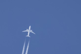 Boeing 787-8 Dreamliner jet passenger aircraft of Aeromexico flying in a blue sky with a vapor