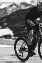 Road bike rider in spring in the Allgäu against the picturesque backdrop of the Alps, Bavaria,